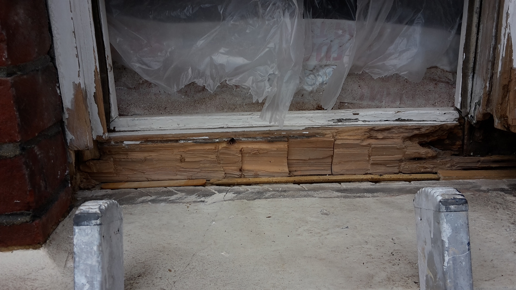 Wood slither cut and placed to support new sill at rear.
